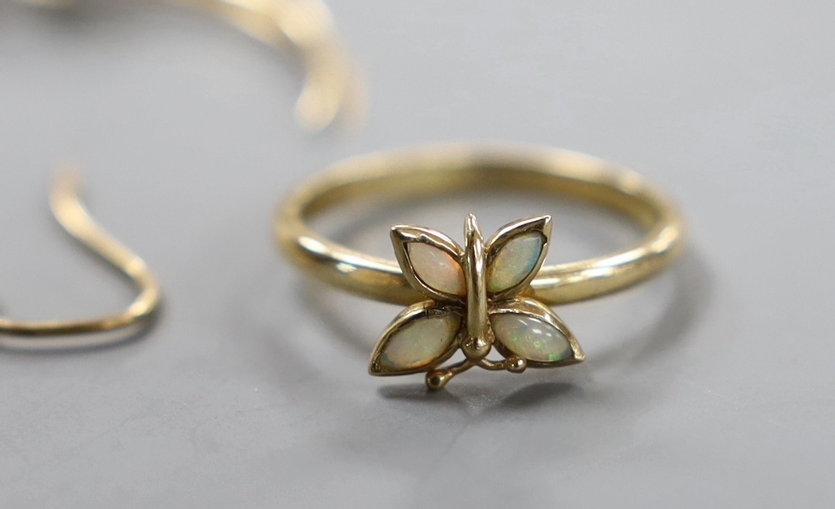 A 14k and gem set 'bird in flight' brooch, 50mm, gross weight 4.1 grams, a 9k and white opal ring, pair of yellow metal and white opal drop earrings and a yellow metal and white opal 'butterfly' ring, gross 6.4 grams.